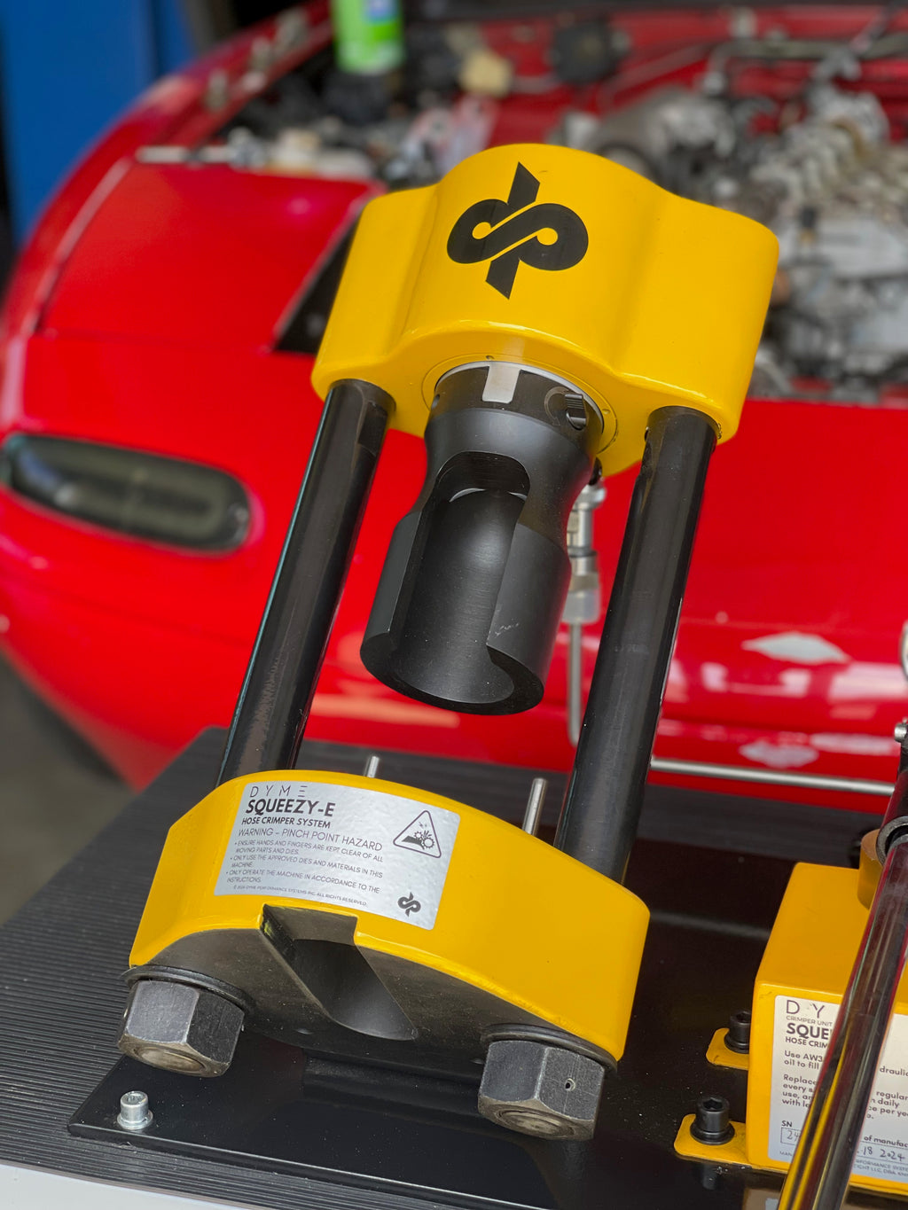 Dyme PRO/SPEC AN adapters crimping tool on a red car